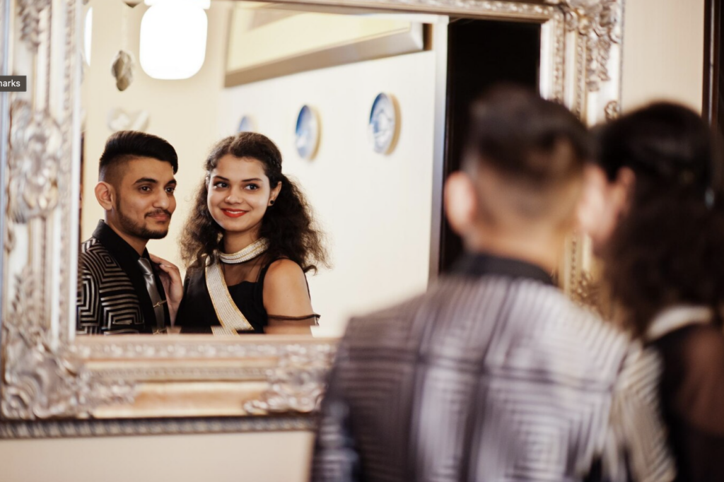 Gen Z hotel guests looking in a mirror and smiling